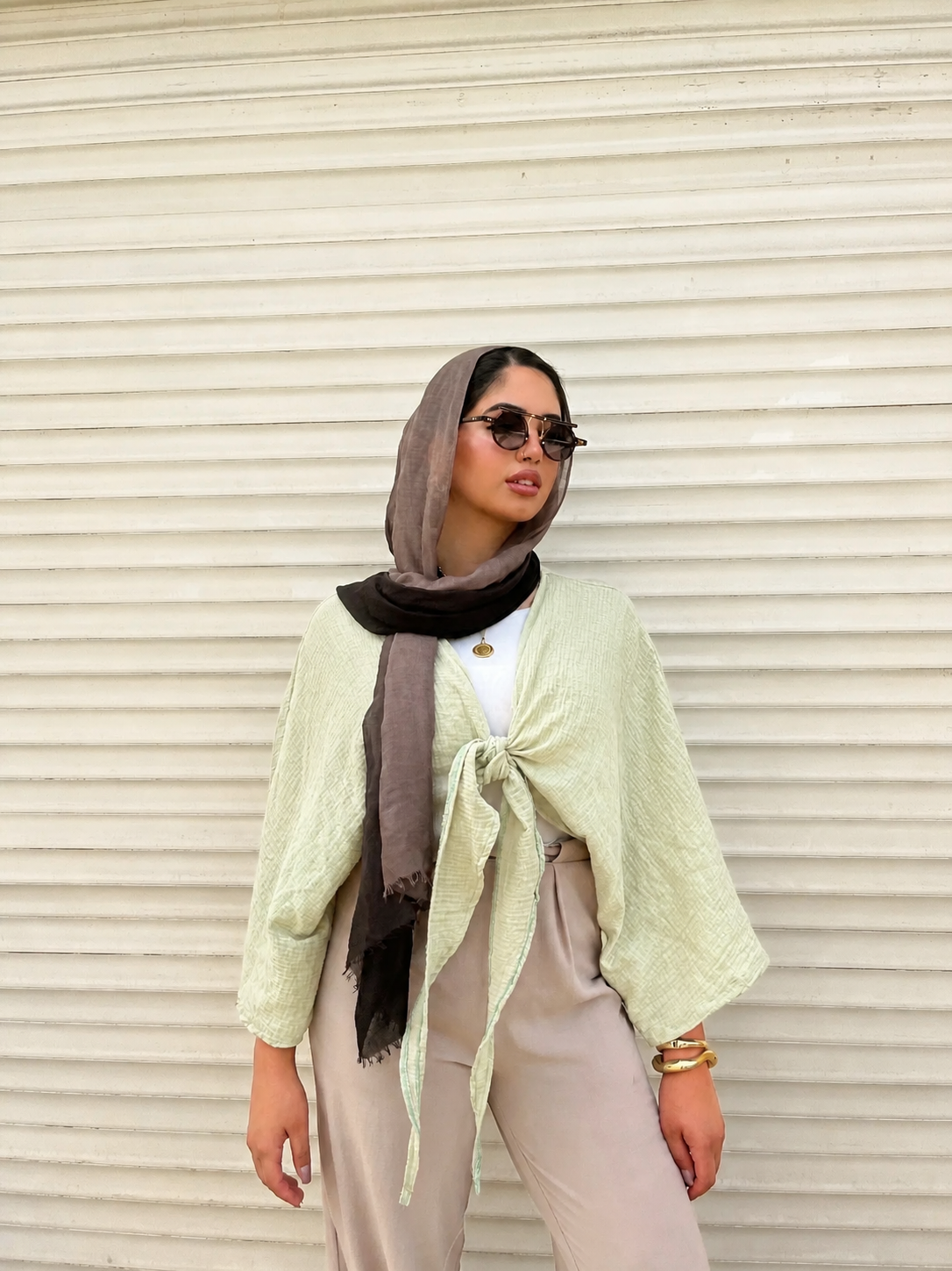 Ocean Breeze Cardigan – soft sage green tie-front cardigan with textured flowy sleeves, styled with neutral tones and elegant accessories for a chic modest summer look.