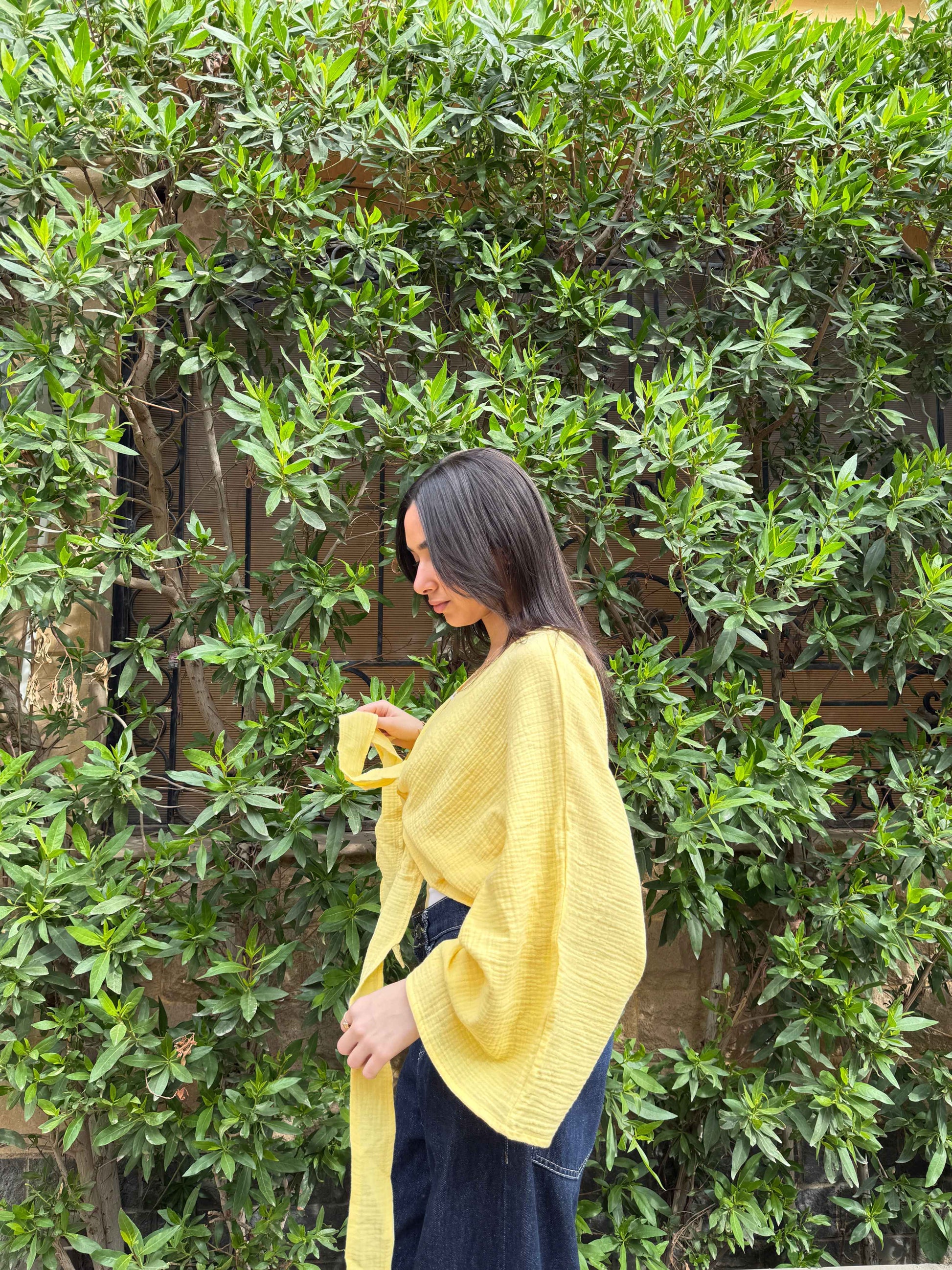 Ocean Breeze Cardigan – lightweight yellow textured cardigan with relaxed flowy sleeves and tie-front detail, captured in a soft side profile for an effortless everyday style.