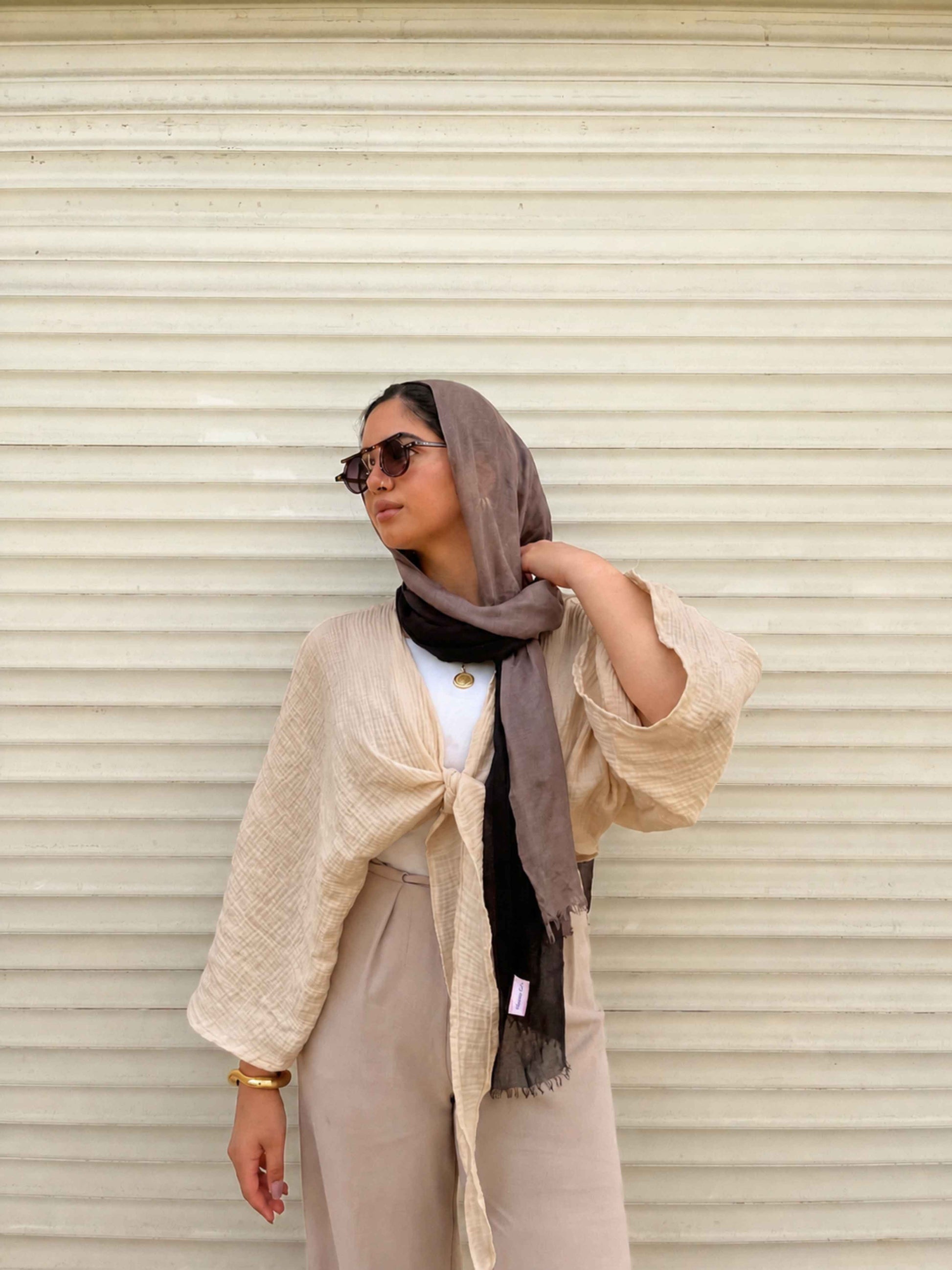 Ocean Breeze Cardigan – lightweight beige tie-front cardigan with relaxed textured sleeves, styled with neutral tones and elegant accessories for a soft modest everyday look.